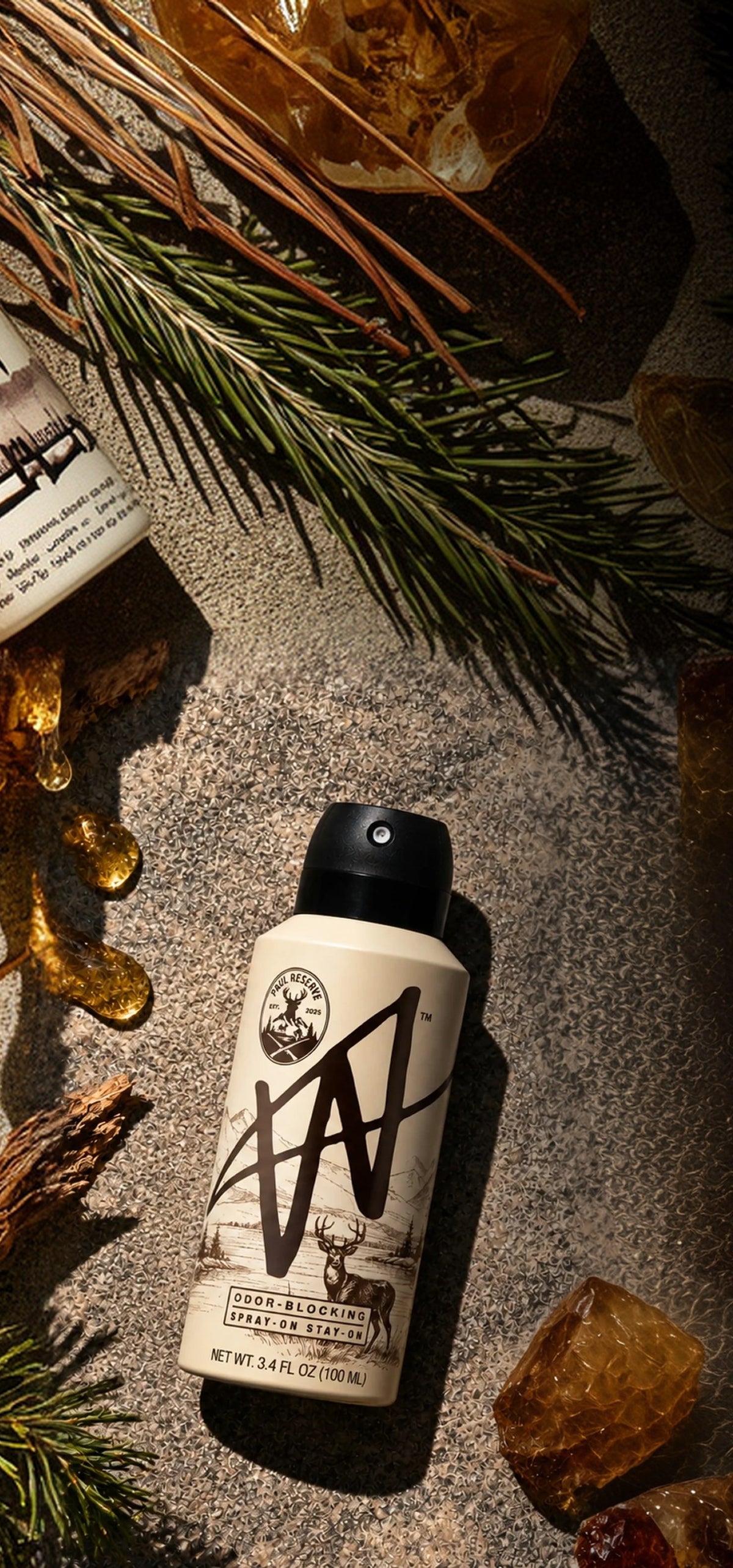 Paul Reserve body spray on sand with pine needles and amber
